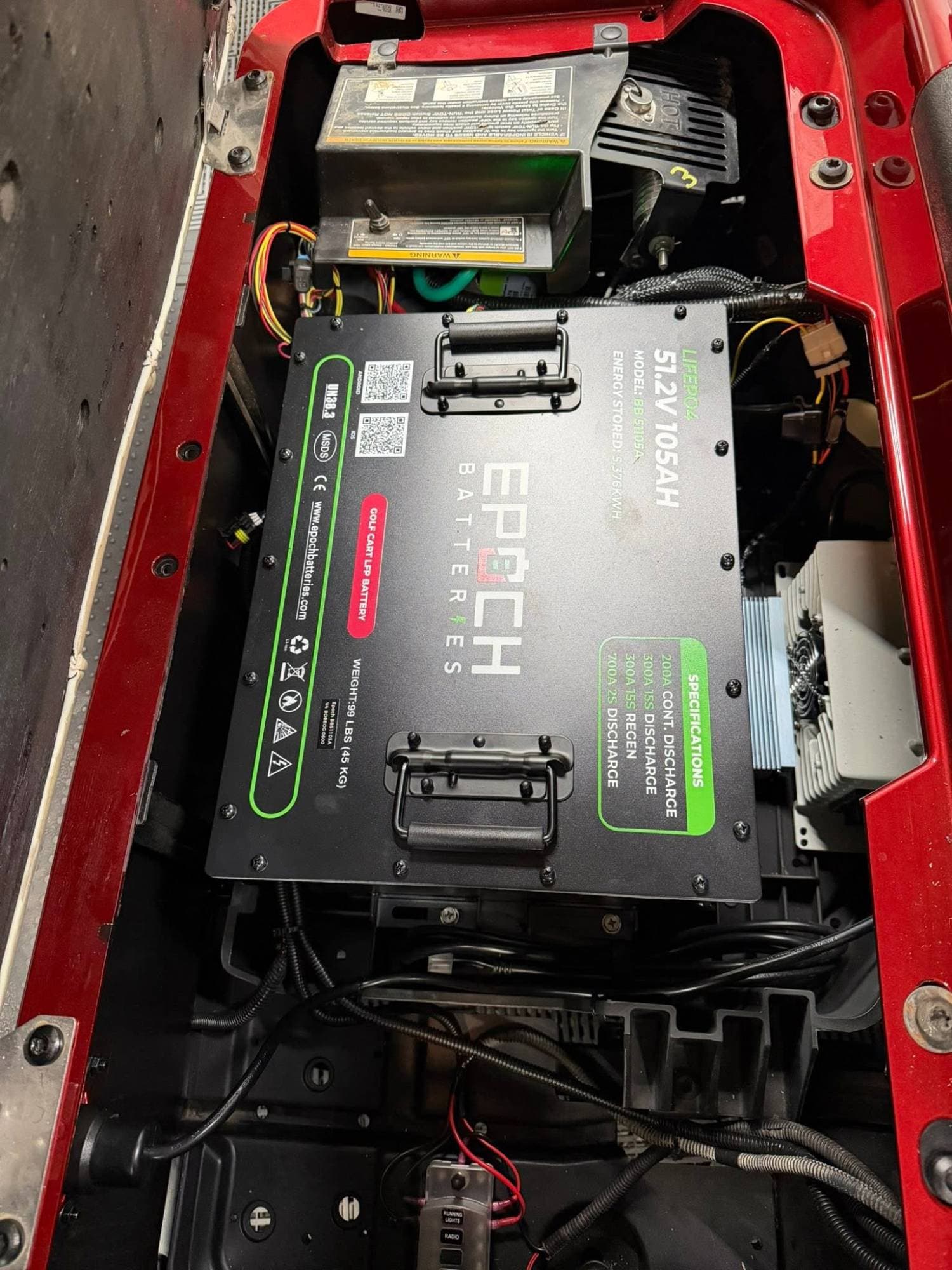 Epoch Big Box 48V 105Ah LiFePO4 golf cart battery installed under the seat of a red golf cart